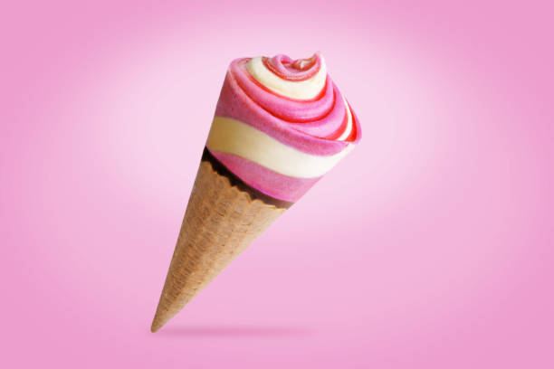 istock Pink and yellow ice cream in waffles cone on a pink background 1323209140