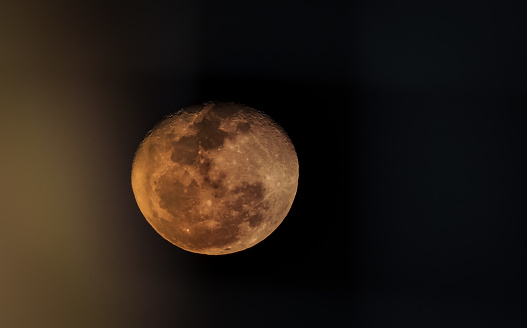 Breathtaking image of the moon at midnight - half blurred with selective focus