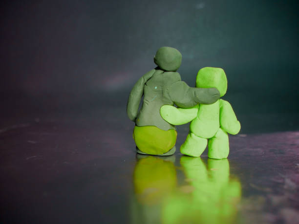 Old man going with robot made concept clay art on gray frame