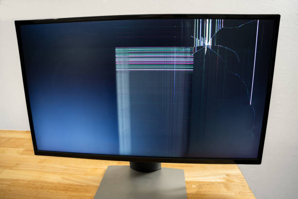 Damaged Computer Monitor, Broken PC Monitor on a Table, Damaged Computer Screen, Smashed PC Monitor stock photo