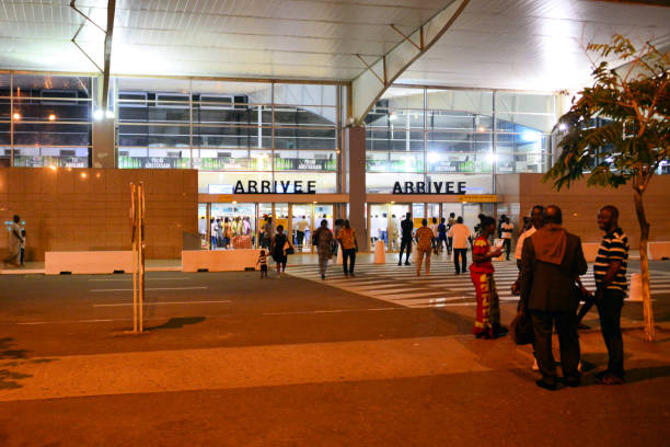 Abidjan Airport, international arrivals - Félix-Houphouët-Boigny International Airport, Abidjan, Ivory Coast Abidjan, Ivory Coast / Côte d'Ivoire: Félix-Houphouët-Boigny International Airport aka Port Bouët Airport - main terminal, people outside the arrivals hall (IATA: ABJ, ICAO: DIAP) abidjan airport stock pictures, royalty-free photos & images