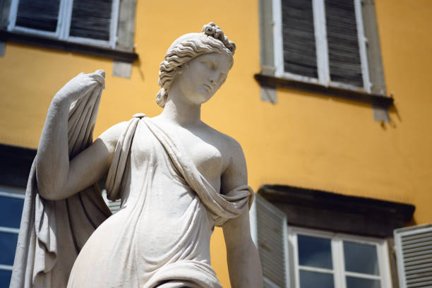 San Salvatore square in Lucca (Tuscany, Italy), detail of the ancient fountain statue of venus with yellow background