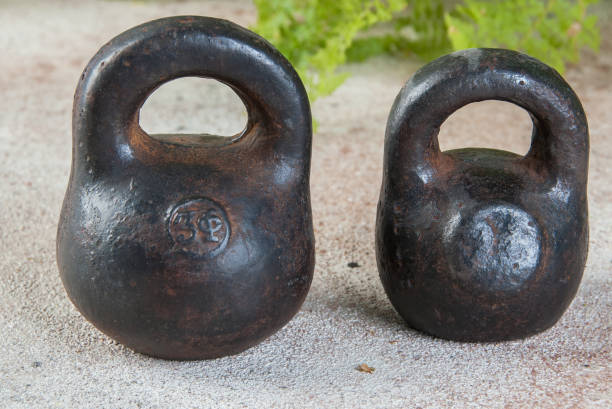 istock Antique iron weights for scales on concrete background. 1323222061