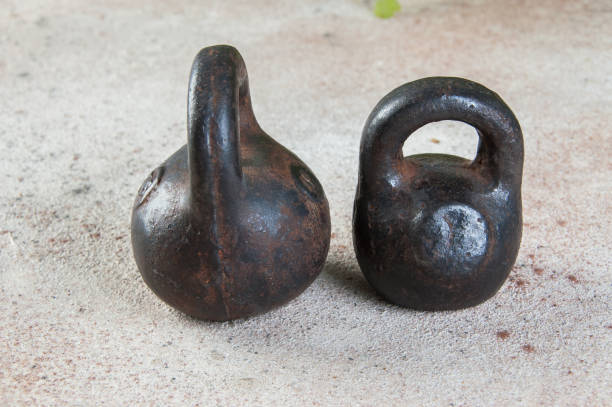 istock Antique iron weights for scales on concrete background. 1323222135