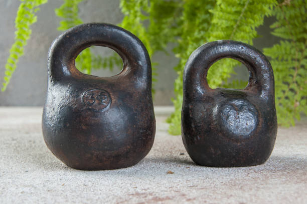 istock Antique iron weights for scales on concrete background. 1323222947
