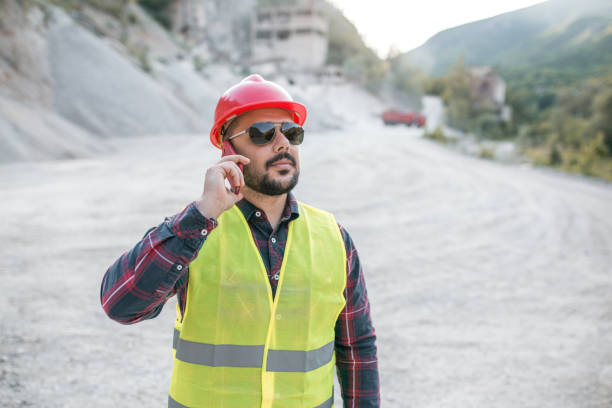 istock Bearded worker in quarry have a phone call 1323226938