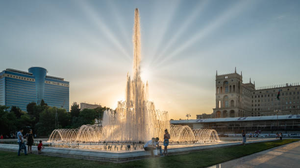 Fountain in Baku National Seaside Park in front of the parliament building in the evening, Azerbaijan Baku, Azerbaijan - July 2019: Fountain in Baku National Seaside Park in front of the parliament building in the evening baku national park stock pictures, royalty-free photos & images