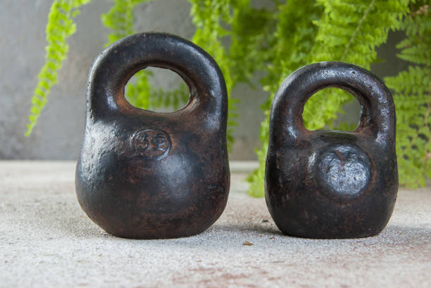 istock Antique iron weights for scales on concrete background. 1323231904