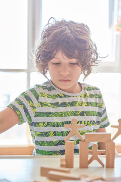 istock Cute little boy Playing with Wooden Blocks 1323232455