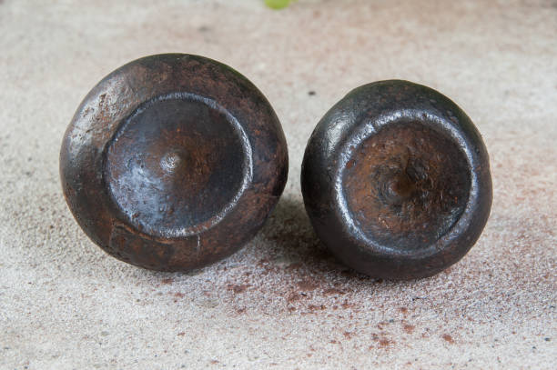 istock Antique iron weights for scales on concrete background. 1323232690