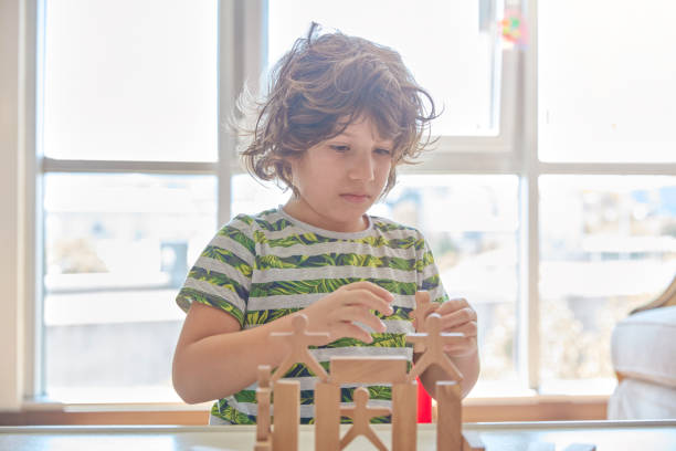 istock Cute little boy Playing with Wooden Blocks 1323232940