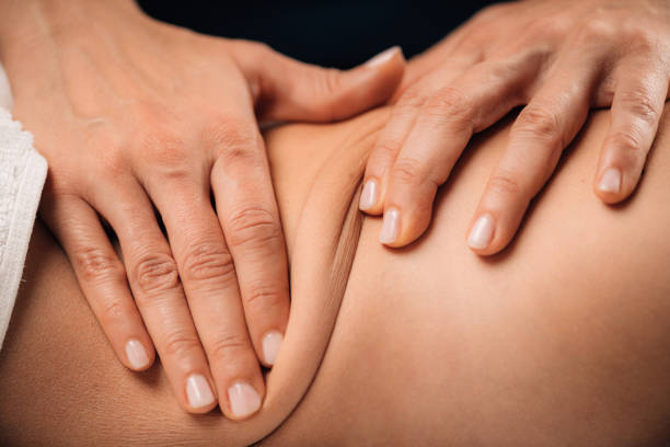 istock Hands of a Female Therapist doing a Deep Tissue Back Massage 1323233866