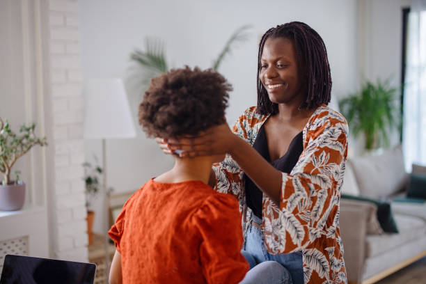 istock Mother styling daughter's hair 1323233876