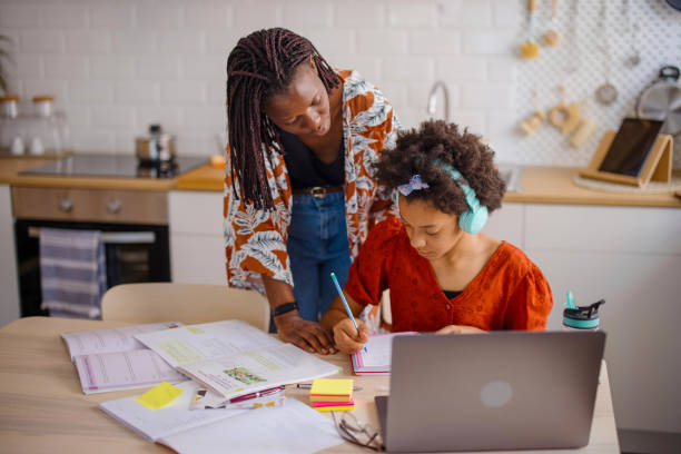 istock Mother helps her daughter with homework 1323234969