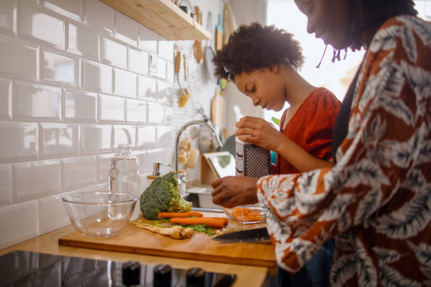 istock Mother and daughter cooking together 1323235002