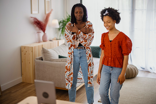 Mom and daughter dancing  and making video at home, tik tok concept