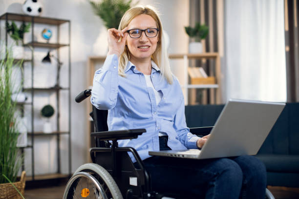 istock Woman with disabilities working on laptop at home 1323236265