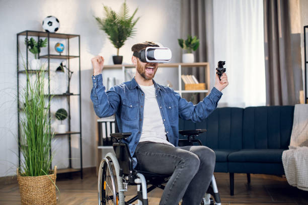 istock Man wearing virtual goggles while sitting in wheelchair 1323237014