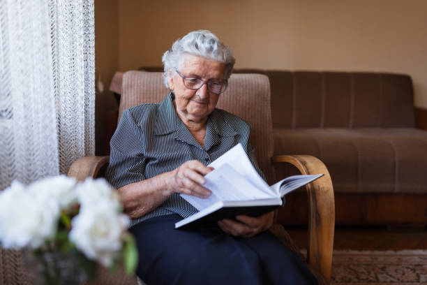 istock Happy senior woman reading a book 1323239434