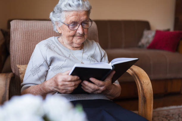 istock Senior woman reading a book 1323239449
