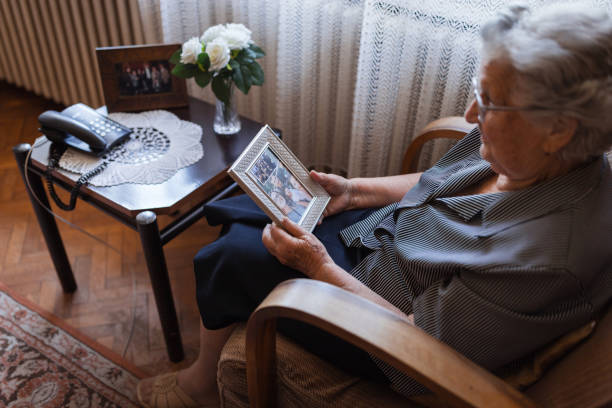 istock Senior nostalgic woman looking at old photo 1323239453