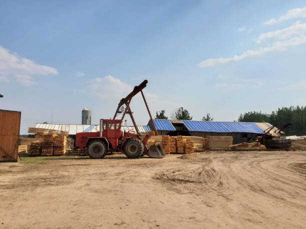 istock Lumber Warehouse with Tractor. Sawmill industry 1323243303