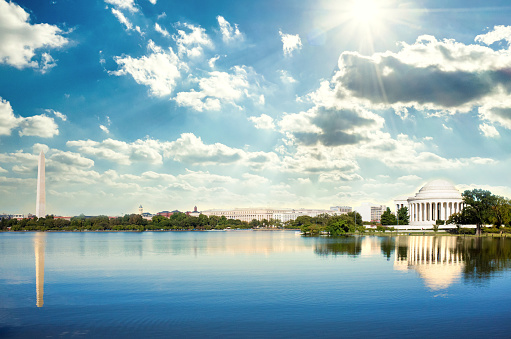 The Washington Monument and Jefferson Memorial in Washington DC reflecting over the waters of the Potomac rivert.