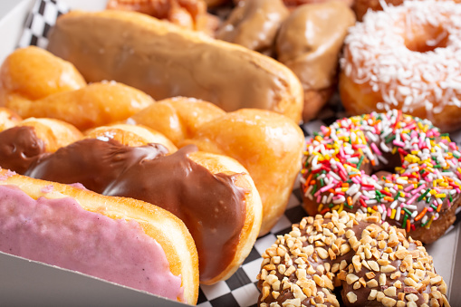 A view of several popular donuts in a pink box.