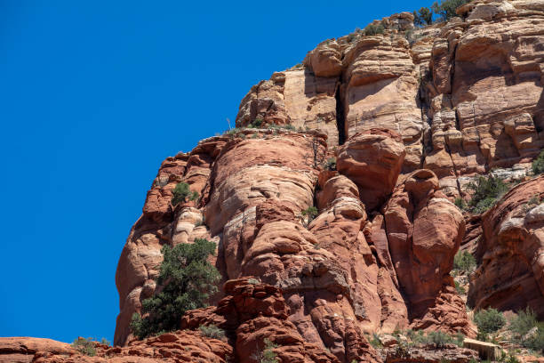 Sedona's stone mountains, characterized by their vivid red sandstone formations and towering cliffs, create a striking contrast against the desert landscape. These natural monuments dominate the horizon with steep ridges and dramatic buttes, providing a rugged yet beautiful environment for exploration.