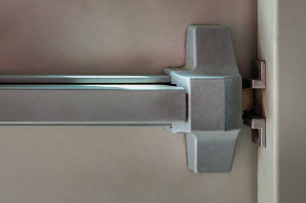 istock Close-up of latch and door handle of emergency exit. Push bar and rail for panic exit. Open one way door, Steel of handle for the door fire exit, Panic fire exit devices, 1323254552