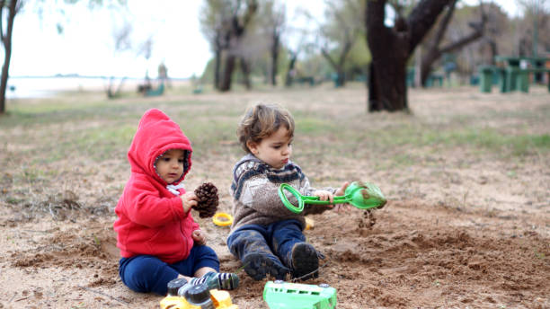istock child playing with water and sand 1323257121