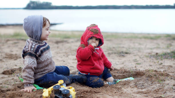 istock child playing with water and sand 1323257134