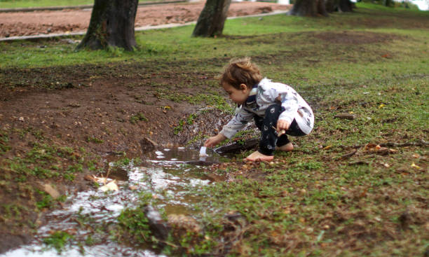 istock child playing with water and sand 1323257999
