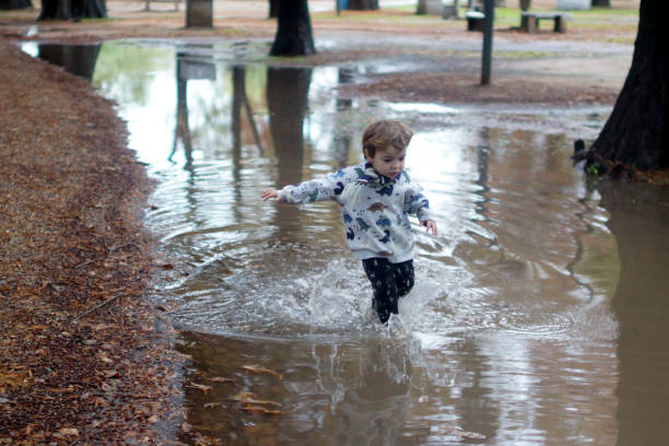 istock child playing with water and sand 1323258000