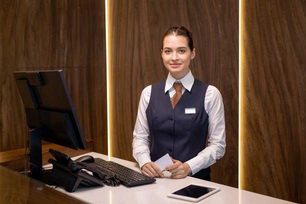istock Happy young receptionist in uniform 1323260460