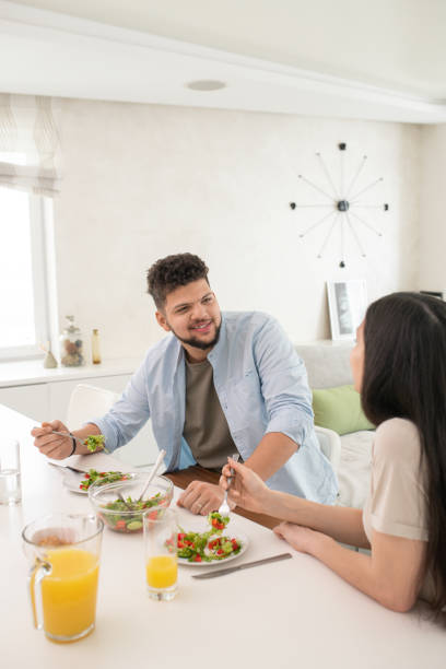 istock Happy young couple having vegetable salad 1323260579
