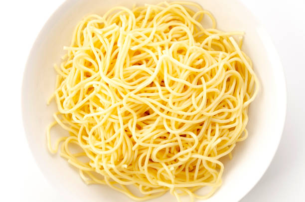 istock Spaghetti Noodles in Plate on White Background 1323260781