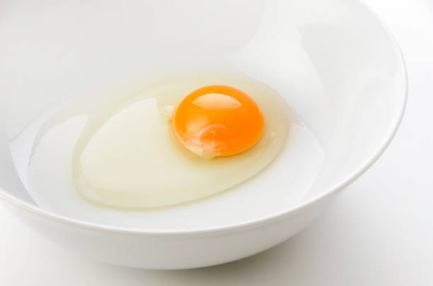 istock yellow egg yolks in a white bowl 1323261408