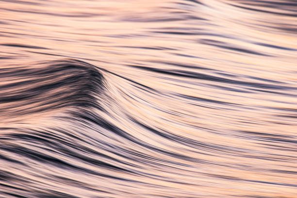 istock Motion blur of golden cresting ocean wave at beach 1323263846