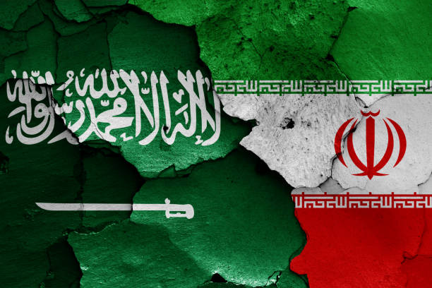istock flags of Saudi Arabia and Iran painted on cracked wall 1323264368