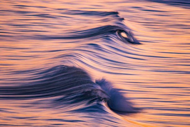 istock Artistic photograph of waves breaking in dramatic afternoon light 1323264409