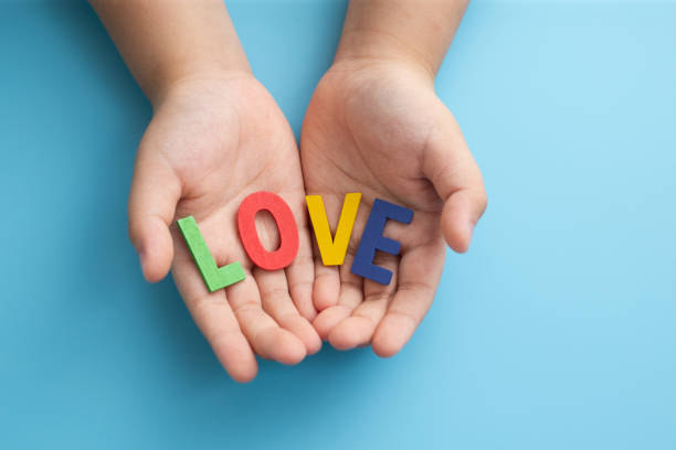 istock Palm oh hand showing LOVE message, love concept. 1323264704