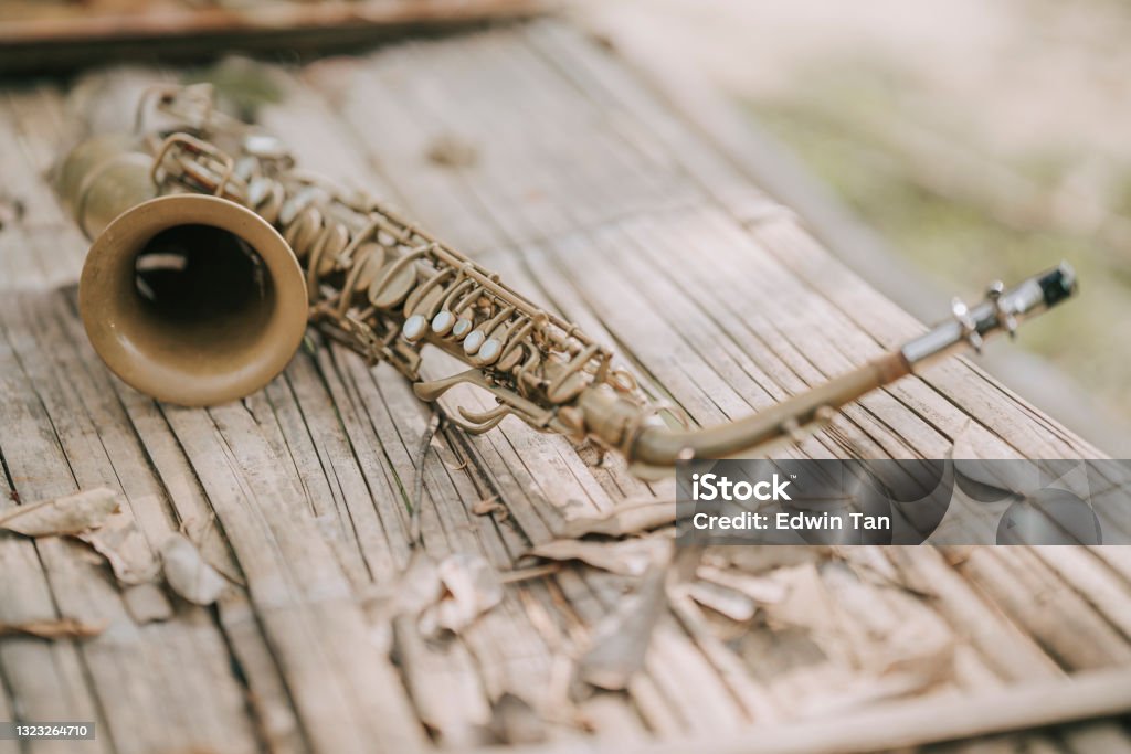 Alto saxophone on wooden table outdoor in woodland Saxophone Stock Photo