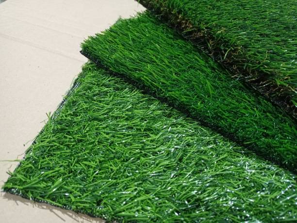 istock Artificial grass pieces. Samples of flooring. Artificial grass close-up. 1323266303