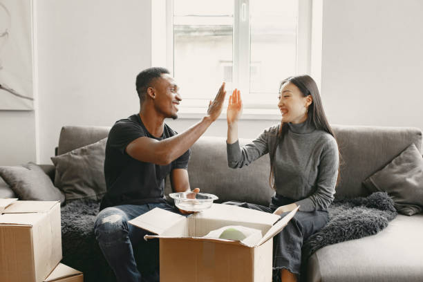 istock Couple unpacking boxes at their new home 1323266584