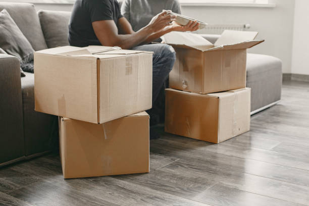 istock Couple unpacking boxes at their new home 1323266815