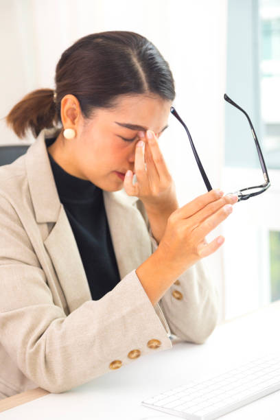 istock Asian businesswomen feel stressed, tired from work, migraine headaches from hard work. 1323268875