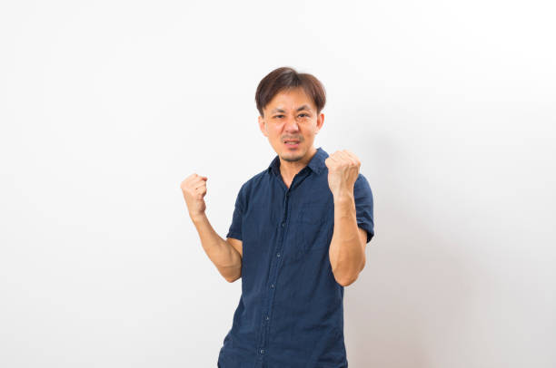 istock A good looking middle age asian man in blue shirt smile 1323269035