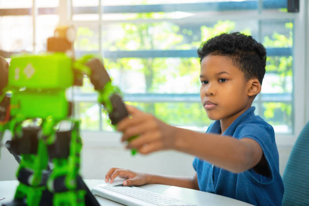 garçon en classe robotique. - computer lab child internet development photos et images de collection