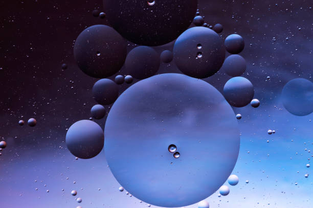 istock translucent oily liquid bubbles on the water surface, oil drops on the water surface 1323278875